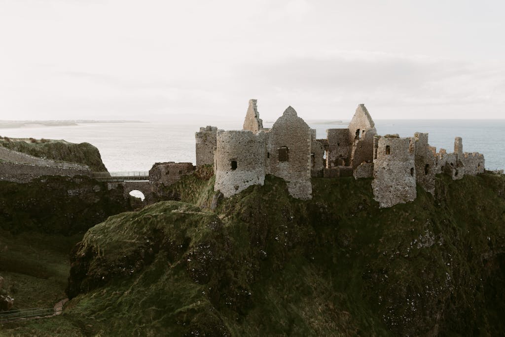 Explore the captivating ruins of Dunluce Castle overlooking the sea in Northern Ireland.